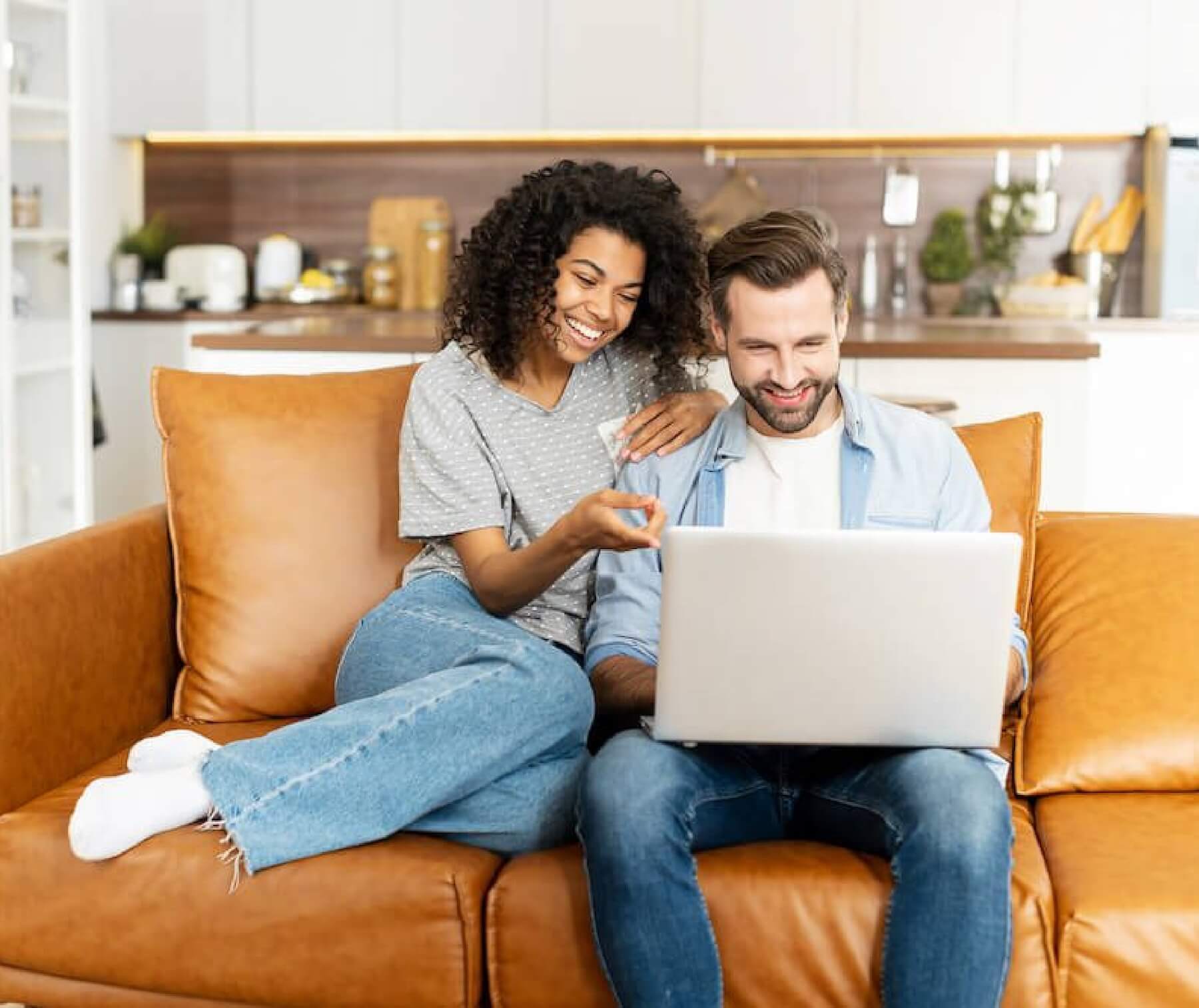 Couple on laptop in apartment.