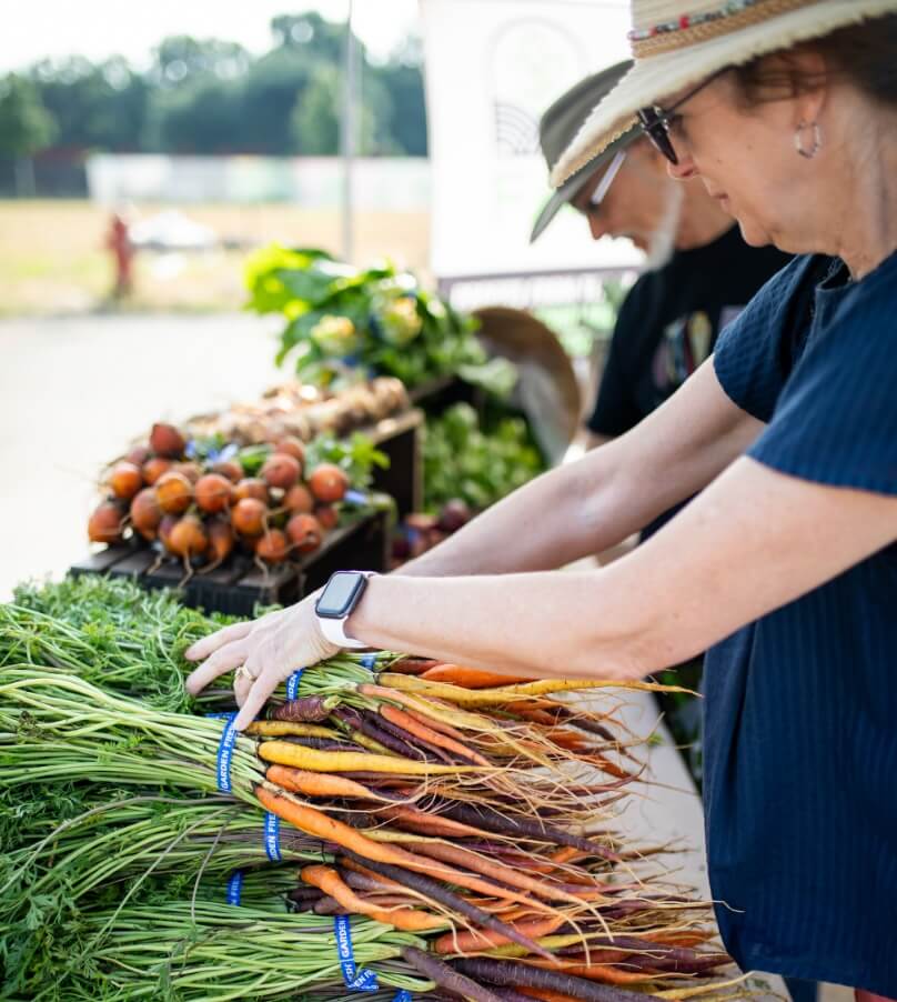 Visitor buying carrots